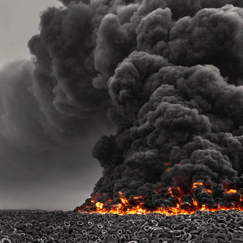 Moving image of a field of tires on fire.